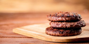 Burger grill on a cutting board. On a wooden background. High quality photo