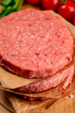 Fresh raw burger on the table. On a wooden background. High quality photo