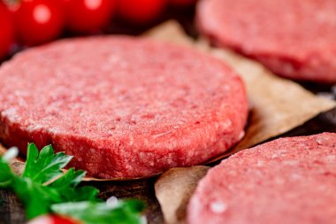 Raw burger with fresh tomatoes. Macro background. High quality photo