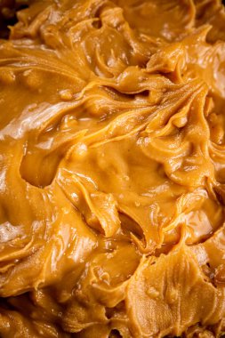 Fresh peanut butter. Macro background. The texture of peanut butter. High quality photo