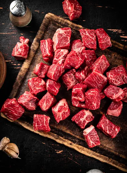 Cut Pieces Raw Beef Cutting Board Dark Background High Quality Jogdíjmentes Stock Fotók