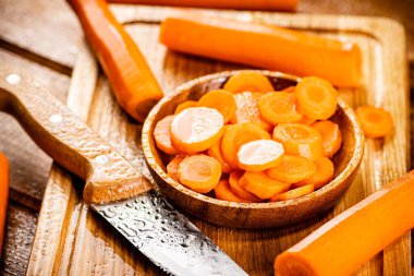 Sliced fresh carrots. On a wooden background. High quality photo