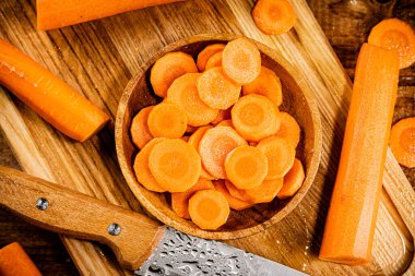 Sliced fresh carrots. On a wooden background. High quality photo