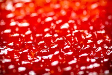 Grains of delicious red caviar. Macro background. Red caviar texture. High quality photo