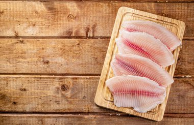 Fresh fish fillet on a cutting board. On a wooden background. High quality photo