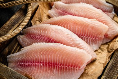 Delicious raw fish fillet on a wooden tray. Macro background. High quality photo