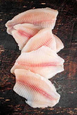Fresh raw fish fillet on the table. Against a dark background. High quality photo