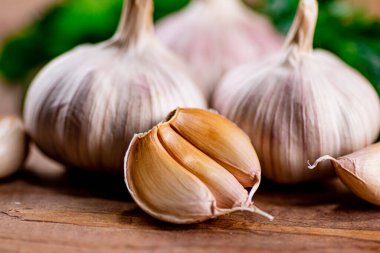Cloves of fresh garlic on the table. On a wooden background. High quality photo