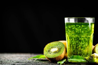 A glass of fresh kiwi juice. On a black background. High quality photo