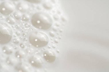 Fresh milk with air bubbles. Macro background. High quality photo