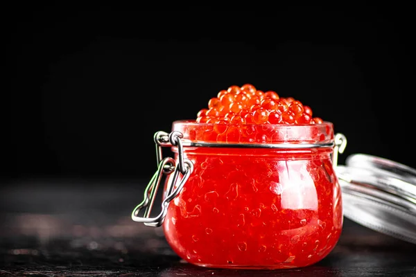 Open Glass Jar Full Red Caviar Black Background High Quality — стоковое фото