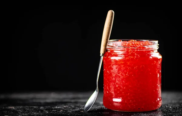 Red Caviar Glass Jar Table Spoon Black Background High Quality — стоковое фото