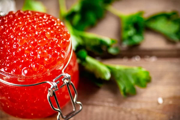 Red Caviar Glass Jar Parsley Wooden Background High Quality Photo — стоковое фото