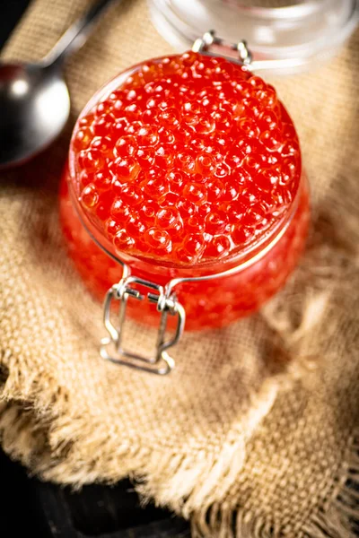 Glass Jar Red Caviar Burlap Black Background High Quality Photo — Fotografia de Stock