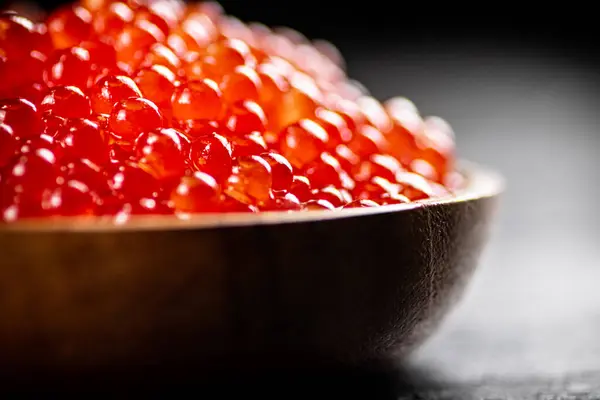 Red Caviar Wooden Plate Black Background High Quality Photo — стоковое фото