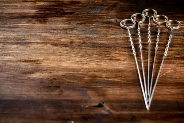 stock image Skewers for kebab on the table. On a wooden background. High quality photo