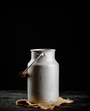 A can of milk on a napkin. On a black background. High quality photo