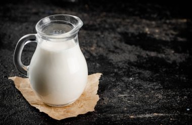 A full jug of fresh milk. On a black background. High quality photo