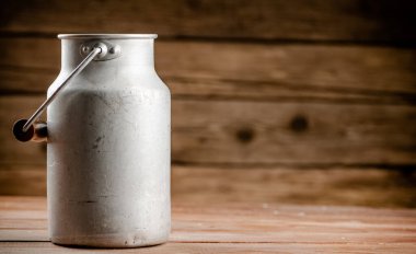 A can of village milk. On a wooden background. High quality photo