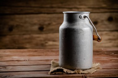 A can of village milk. On a wooden background. High quality photo