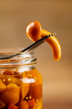 One marinated mushroom on a fork. Macro background. High quality photo