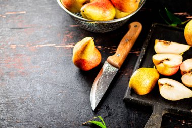 Sliced fresh pear on a cutting board. Against a dark background. High quality photo