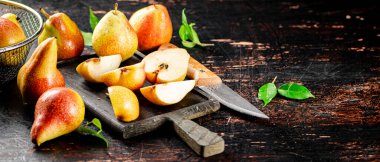 Sliced fresh pear on a cutting board. Against a dark background. High quality photo