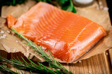 A piece of salted salmon on paper. Macro background. High quality photo