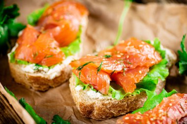 Salmon sandwich on paper. Macro background. High quality photo