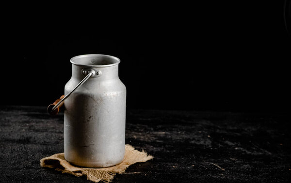 A can of milk on a napkin. On a black background. High quality photo