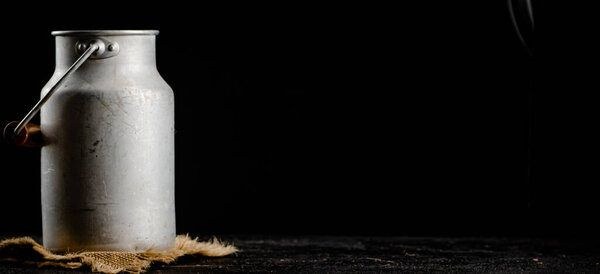A can of milk on a napkin. On a black background. High quality photo