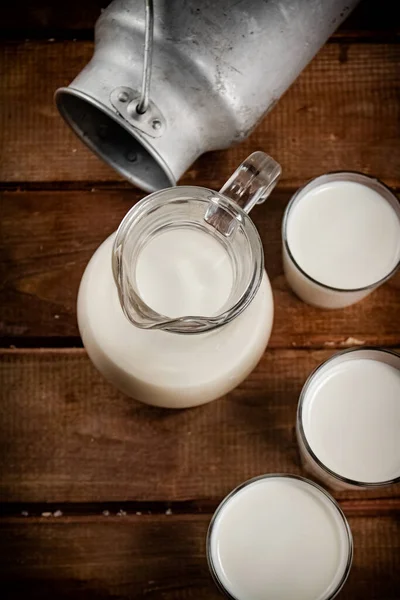 Milk Jugs Glasses Wooden Background High Quality Photo — Fotografia de Stock