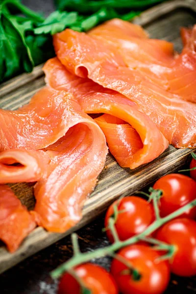 Slices Salted Salmon Greens Tomatoes Cutting Board Dark Background High — Foto Stock
