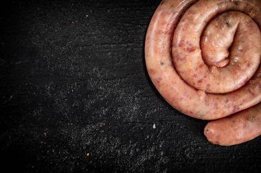 Fresh raw sausages for frying. On a black background. High quality photo