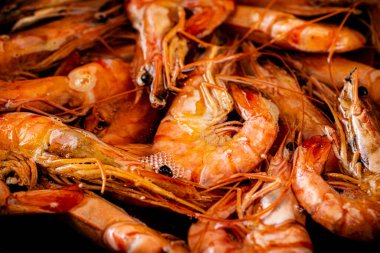 Red shrimp are boiled in water. Macro background. Shrimp texture. High quality photo