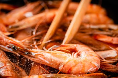 The shrimp are cooked in a pot of water. Macro background. High quality photo
