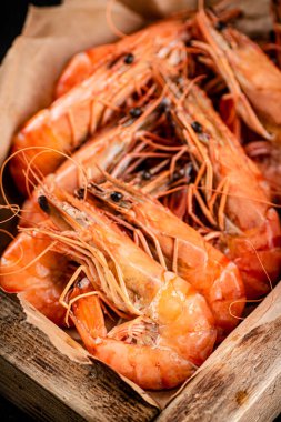 Delicious boiled shrimp on a wooden tray. Macro background. High quality photo