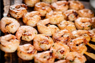 Grilled shrimp on a wooden cutting board. High quality photo