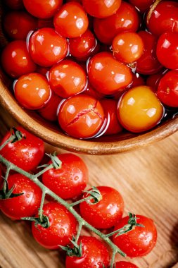 Pickling ripe tomatoes at home. On a wooden background. High quality photo