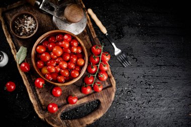 Preparation of tomatoes for pickling on a cutting board. On a black background. High quality photo