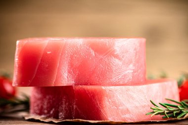 Fresh raw tuna steak on the table. On a wooden background. High quality photo