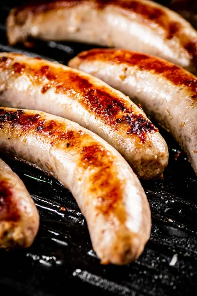 Grilled Sausages Frying Pan Black Background High Quality Photo — стоковое фото