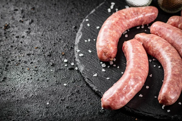 Raw Sausages Stone Board Spices Black Background High Quality Photo — Stok fotoğraf