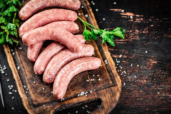 Raw Sausages Cutting Board Parsley Rustic Dark Background High Quality — Stok fotoğraf