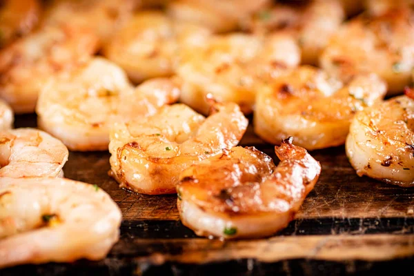 Grilled shrimp on a wooden cutting board. High quality photo