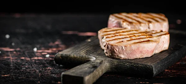 Delicious Grilled Tuna Steak Cutting Board Rustic Dark Background High — Fotografie, imagine de stoc