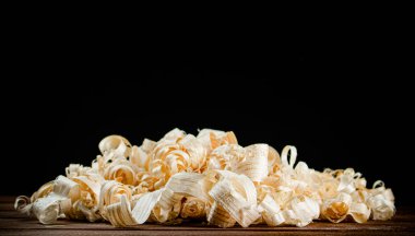 A bunch of wood chips on the table. On a black background. High quality photo