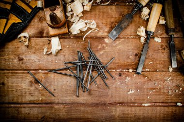 Construction nails on the table. On a wooden background. High quality photo