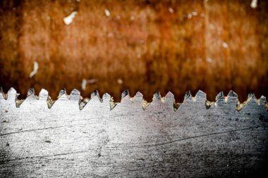 Hand saw blade on a wooden background. High quality photo