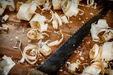 Hand saw with wooden shavings. On a wooden background. High quality photo